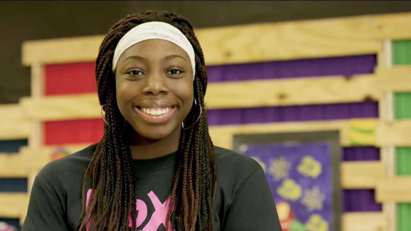 A ROX girl smiling confidently
