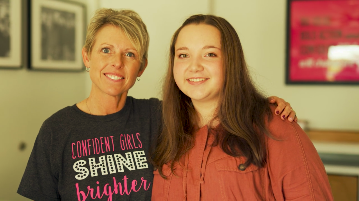 A mom and her ROX girl smiling together